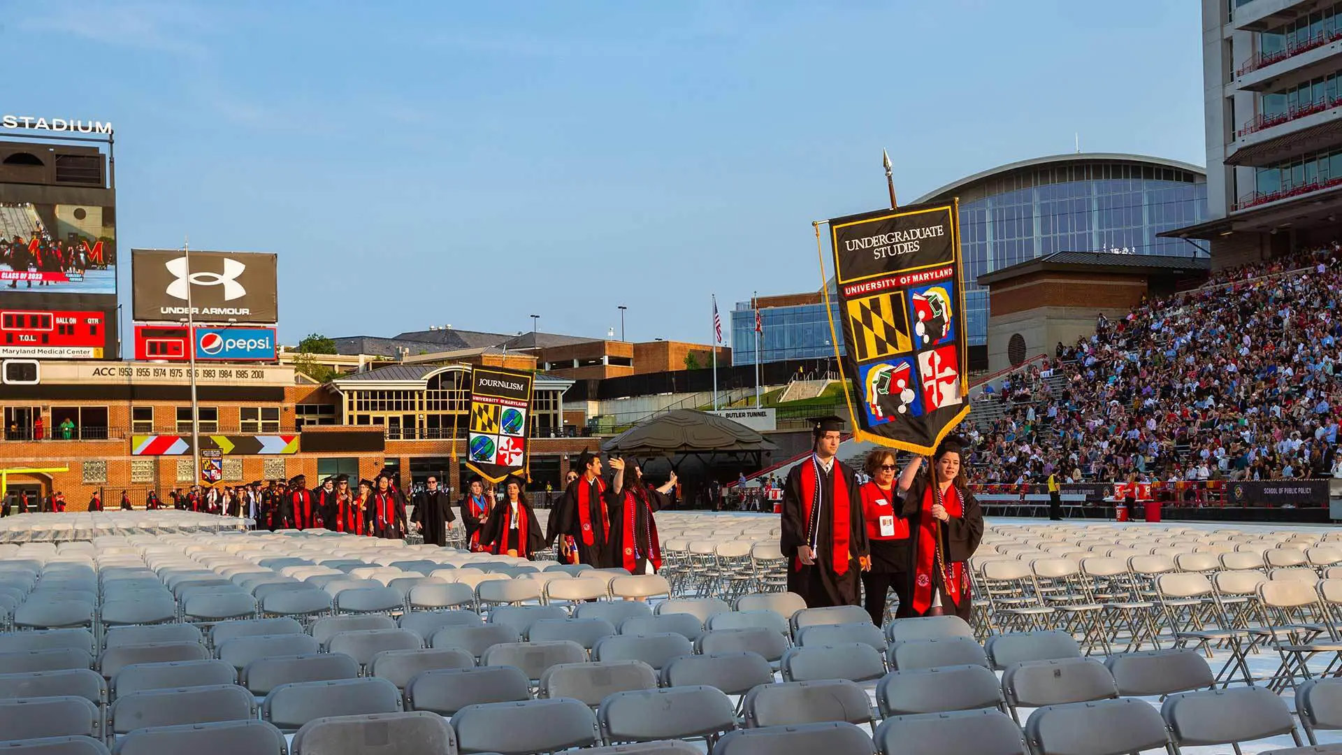 Gonfalons held high, senior marshals from various departments and other units lead graduates into Commencement 2023. This year, 62 outstanding Terp seniors were chosen for the honor.